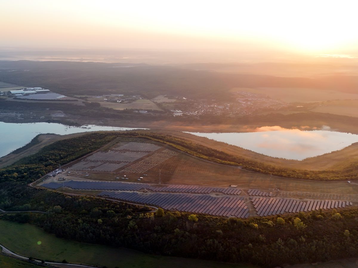 PV farm next to high-voltage lines — drone photo