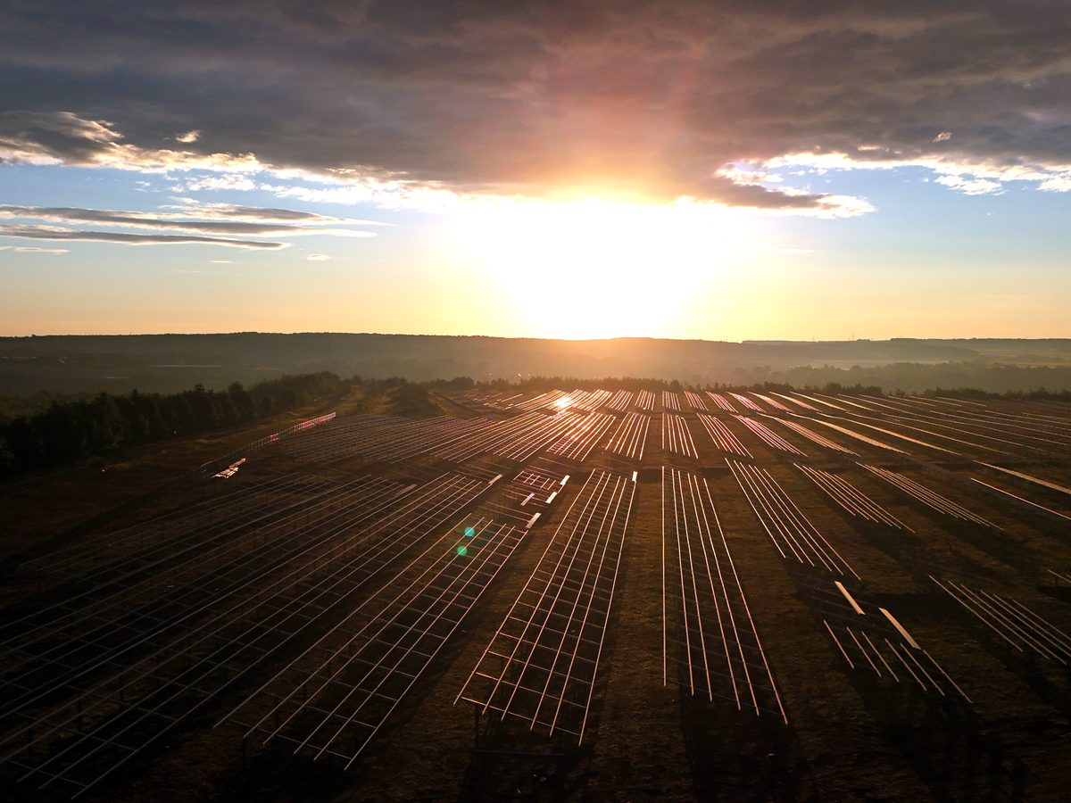 PV farm by the lake at sunset — drone photo