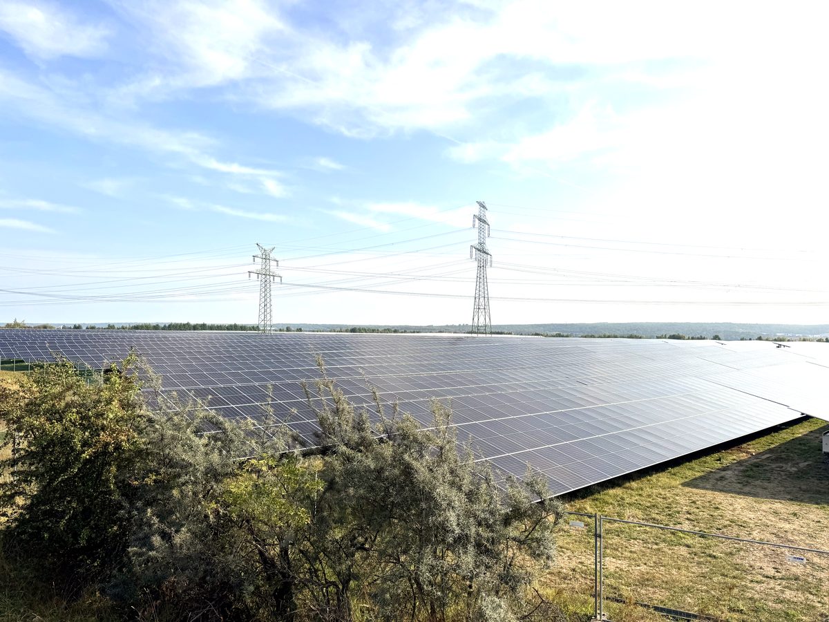 PV farm construction near a transmission tower — drone photo